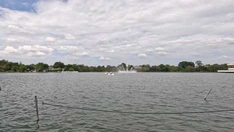 calm water with a fountain in a tranquil setting.