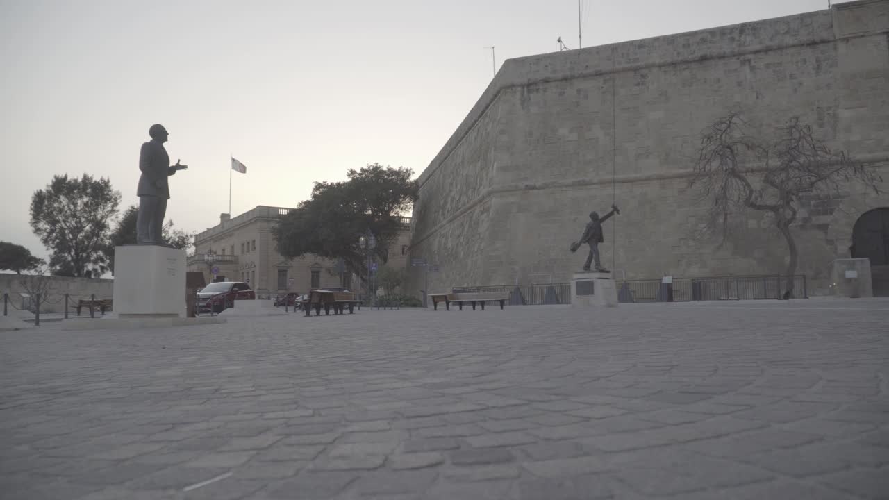 A still shot of an empty main square with different monuments during sunset