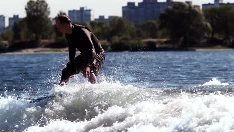 wakeboarder surfing on board on waves. extreme aquatic sport