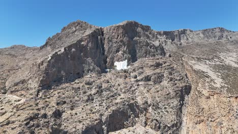 monastery of holy mary hozoviotissa in the island of amorgos | monastery carved in mountain rock | 4k drone shot
