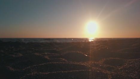 beach sunset with sand in focus and background slightly blurred