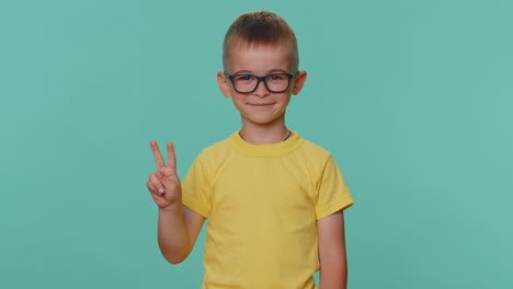 Happy-smiling-toddler-children-boy-showing-victory-sign,-hoping-for-success-win,-doing-peace-gesture