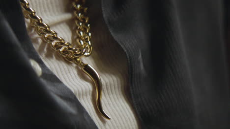 close up of a mafioso's cornicello necklace