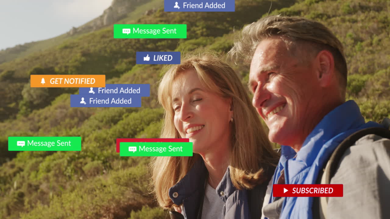 animación de texto e iconos de las redes sociales sobre una pareja caucásica en las montañas