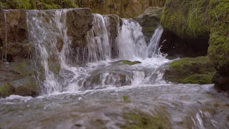 a brook in a gorge in switzerland in solothurn with beautiful little waterfalls leads to a place of choice where a christian hermit used to live