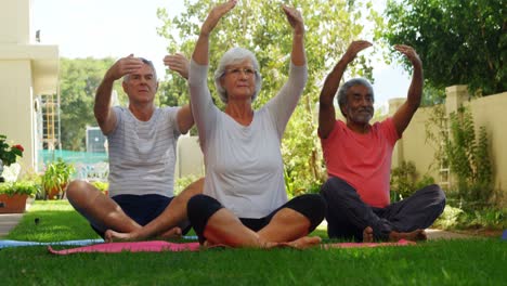 senior friends performing yoga in garden 4k