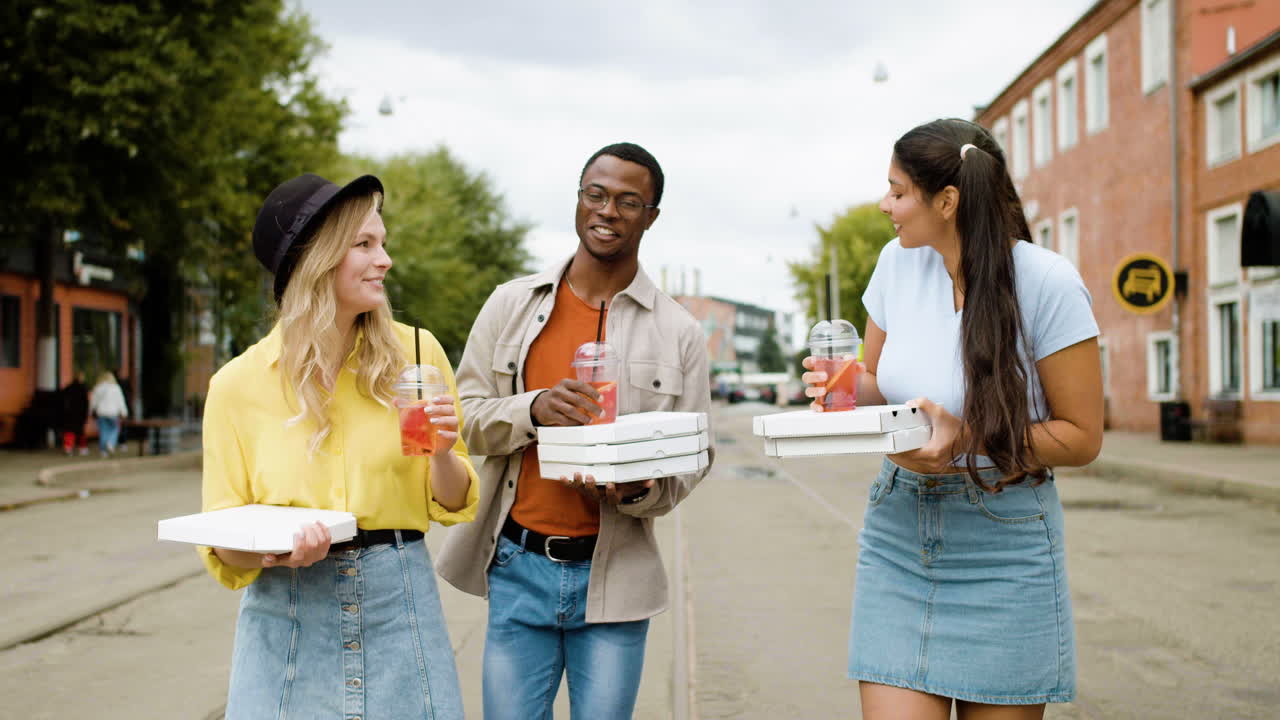 Friends walking on the street with food