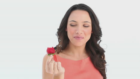 girl sexily eats a part of a strawberry