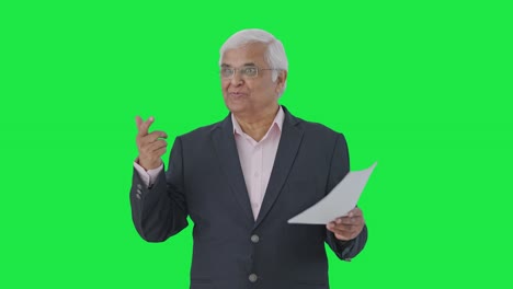 Happy-Indian-senior-manager-discussing-reports-with-employees-Green-screen