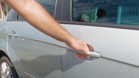 Man-trying-to-open-a-locked-car