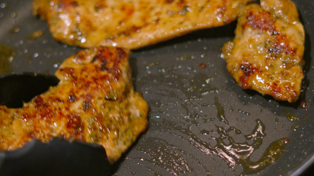 Chef Using Tongs to Move Chinese Flavoured Chicken Steak Fillets Around Hot Frying Pan. Food Photography Footage 4K.