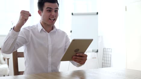 businessman using tablet for business and celebrating success