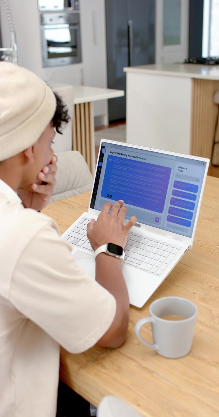 Vertical video: Seeing purple-blue screen, user is reading and typing on laptop at table to send