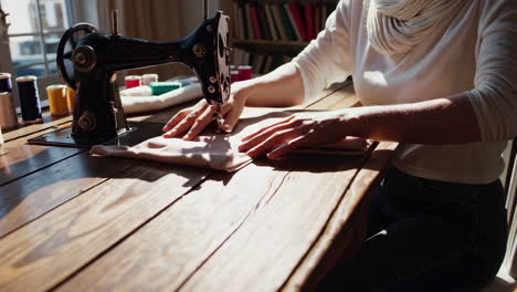 woman sewing on a vintage sewing machine