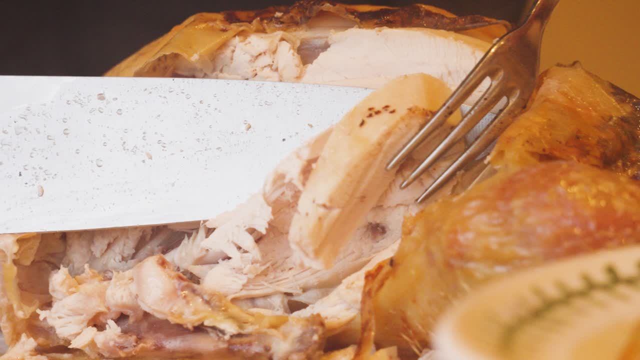 Roasted Whole Chicken Being Carved at Dinner Table with Sharp Knife and Served on Plate. Poultry High Protein Meal Being Served to Family and Guests 4K.