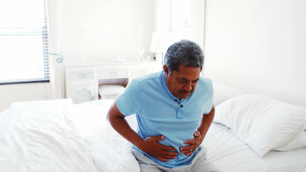 Upset senior man suffering from stomachache 4k