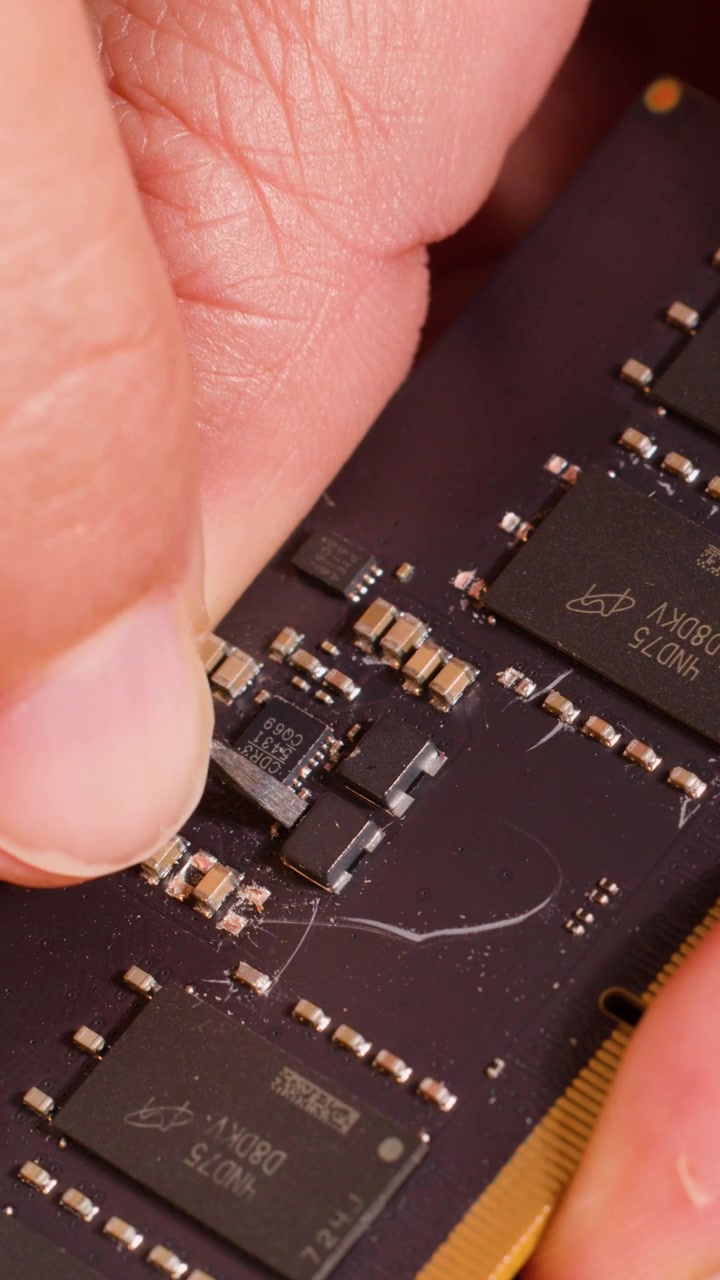 Macro shot of a technician using a tool to repair a computer RAM memory module