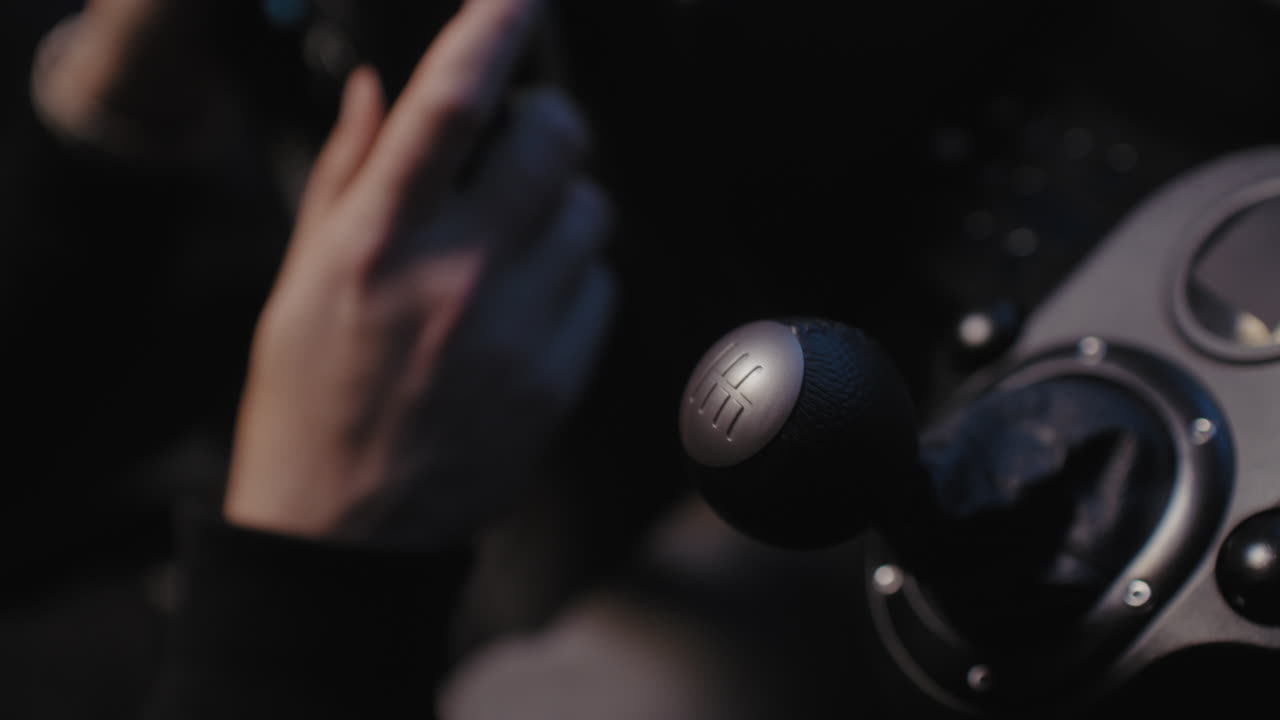 Close-up of a driver's hands on a car's gear shift