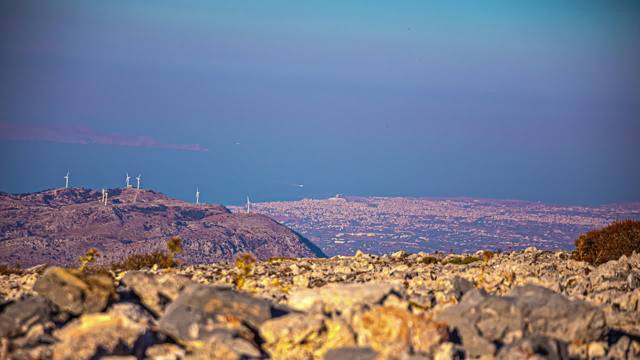 Crete, Greece as seen from atop the Skinakas Observatory, wind turbines on the mountain and the Mediterranean Sea - time lapse