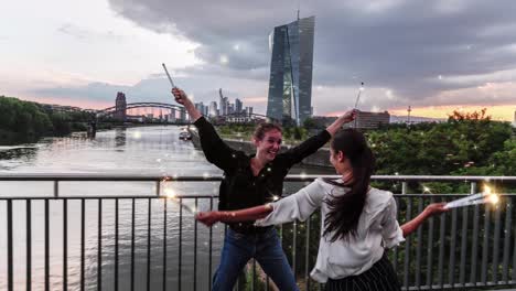 young women holding animated sparklers with city background