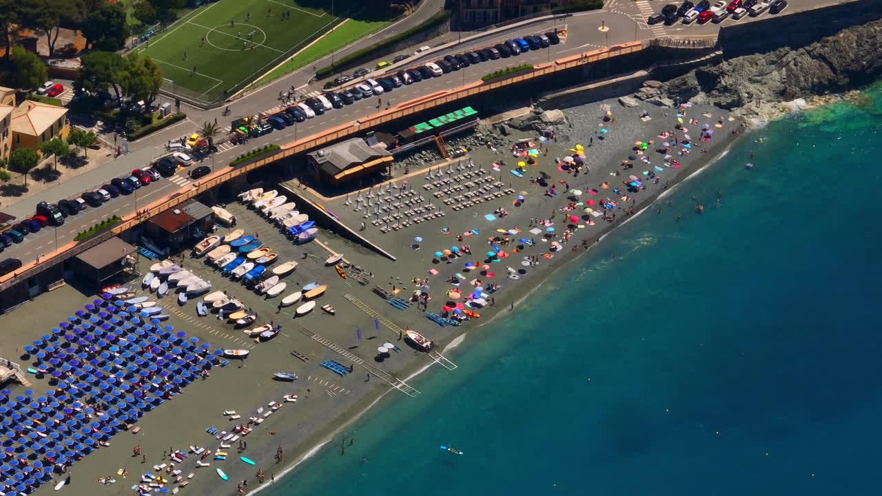 Telephoto drone shot of the busy beach at the Bonassola town, sunny day in Italy