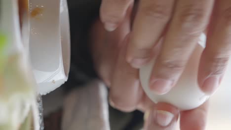 Hands peeling a boiled egg