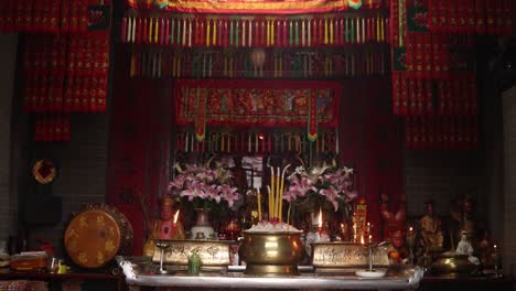 beautiful interior of a traditional temple in macau, china, featuring incense, offerings, and vibrant decorations in a spiritual and cultural setting.