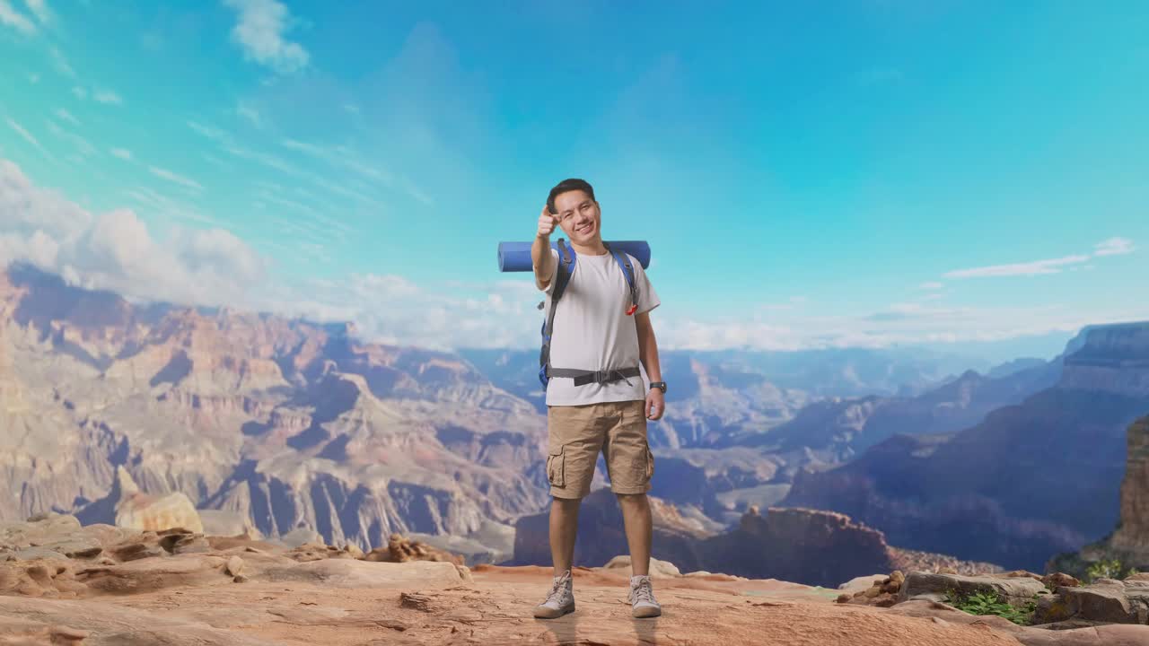 Full Body Of Asian Male Hiker With Mountaineering Backpack Smiling, Touching His Chest, And Pointing To Camera While Traveling At The Top Of Mountain