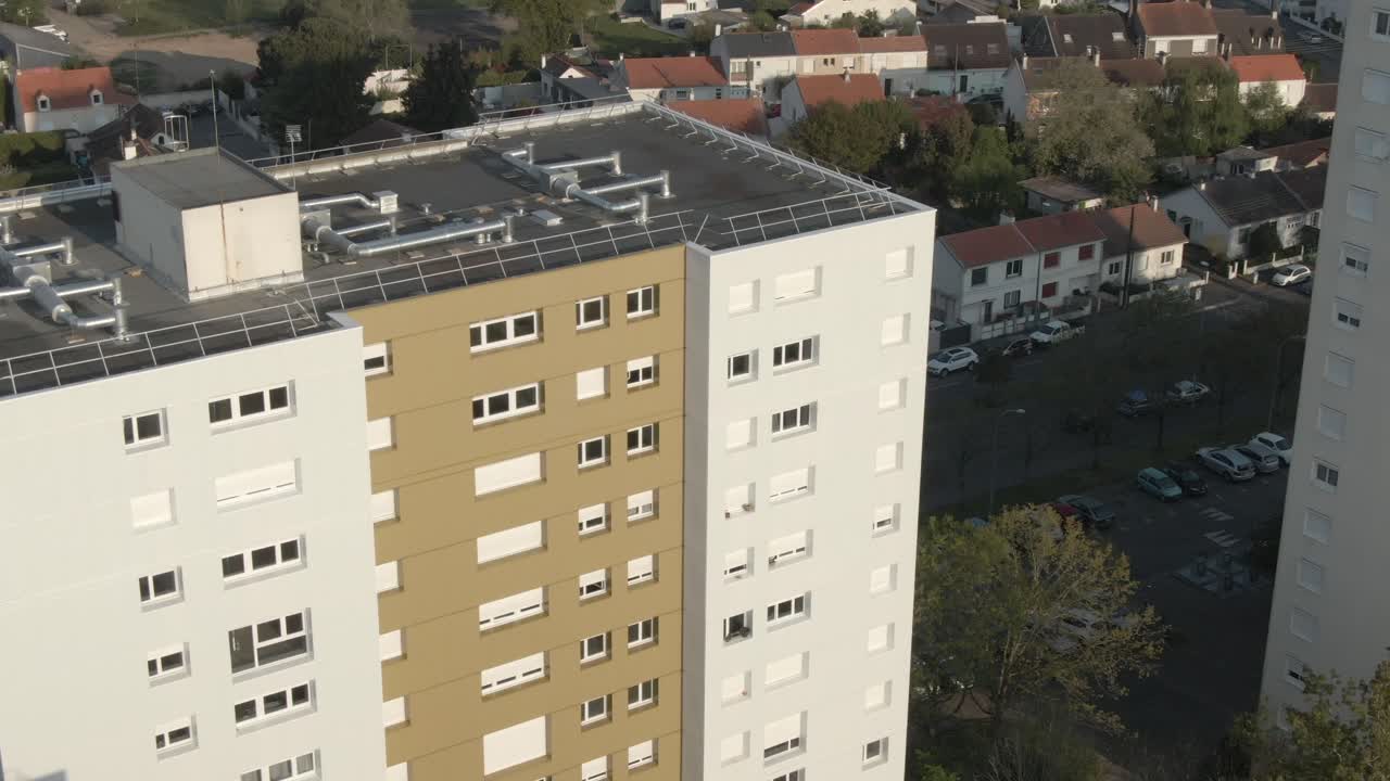Aerial view captures facade of a tall residential building in Nantes, highlighting windows and balconies. Urban living scene, France