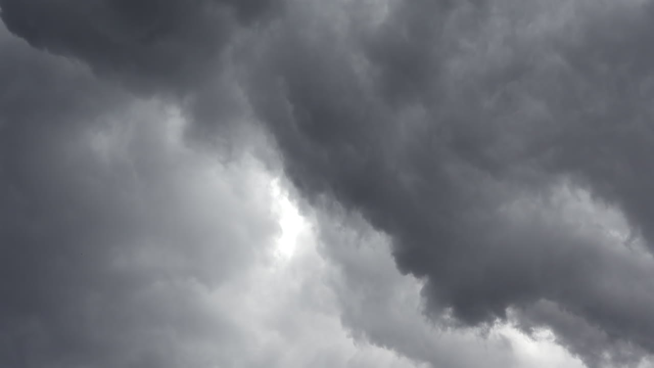 Low angle view of grey clouds moving on the sky