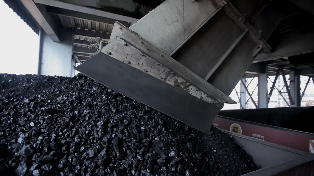 coal factory duping industrial raw material on train wide shot