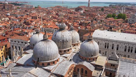 tilt down from top of venice revealing five domes of basilica di san marco