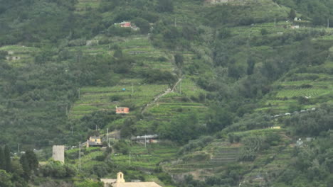 Wide-view-of-the-mountains-in-Monterosso-al-Mare,-Italy-with-drone-video-moving-down-to-the-Convent-of-the-Capuchin-Friars-on-the-Liguria-Sea