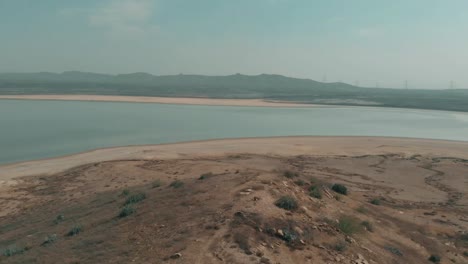 Aerial-Over-Arid-Coastline-Next-To-Salt-Lake-In-Karachi,-Pakistan