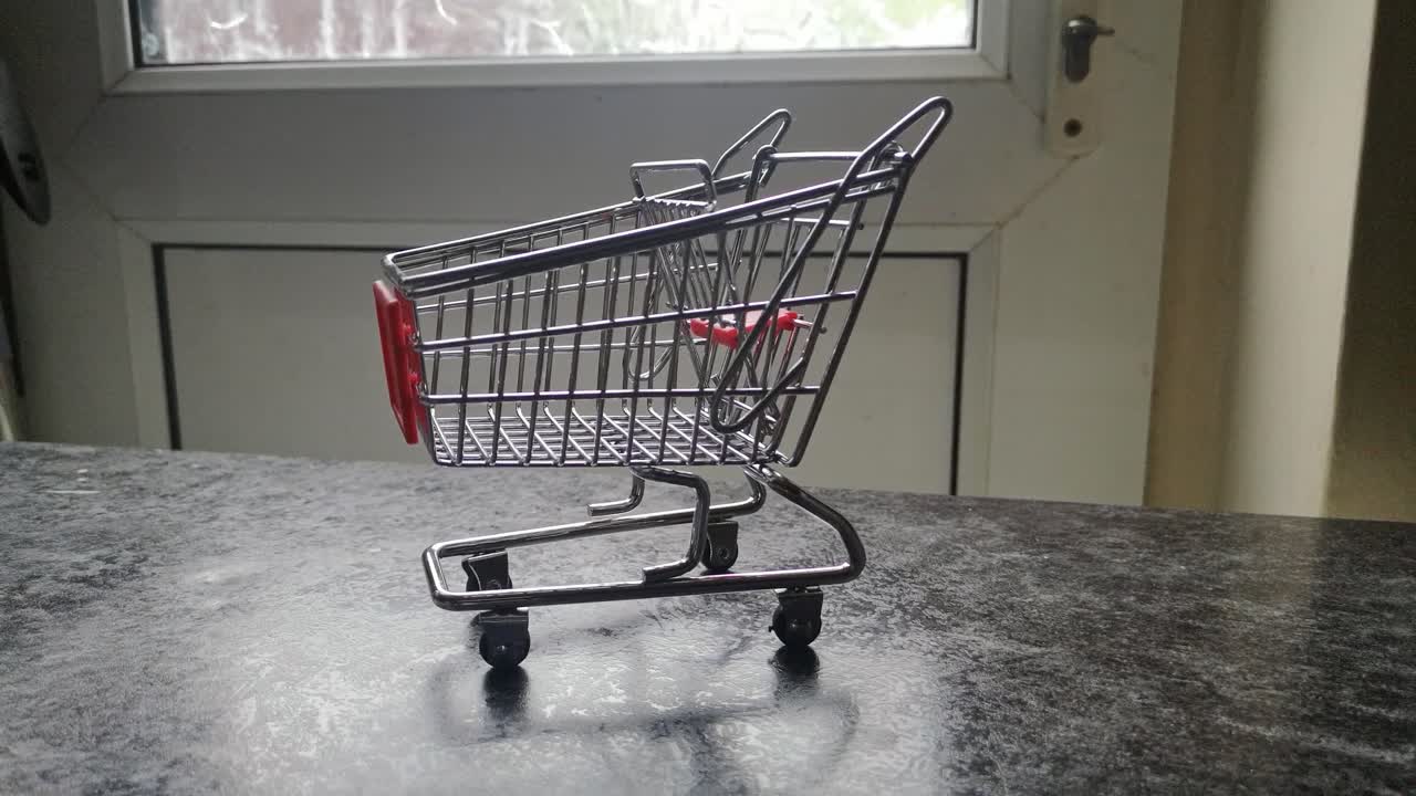 Mini empty shopping cart online home supermarket concept copy space closeup tracking shot right