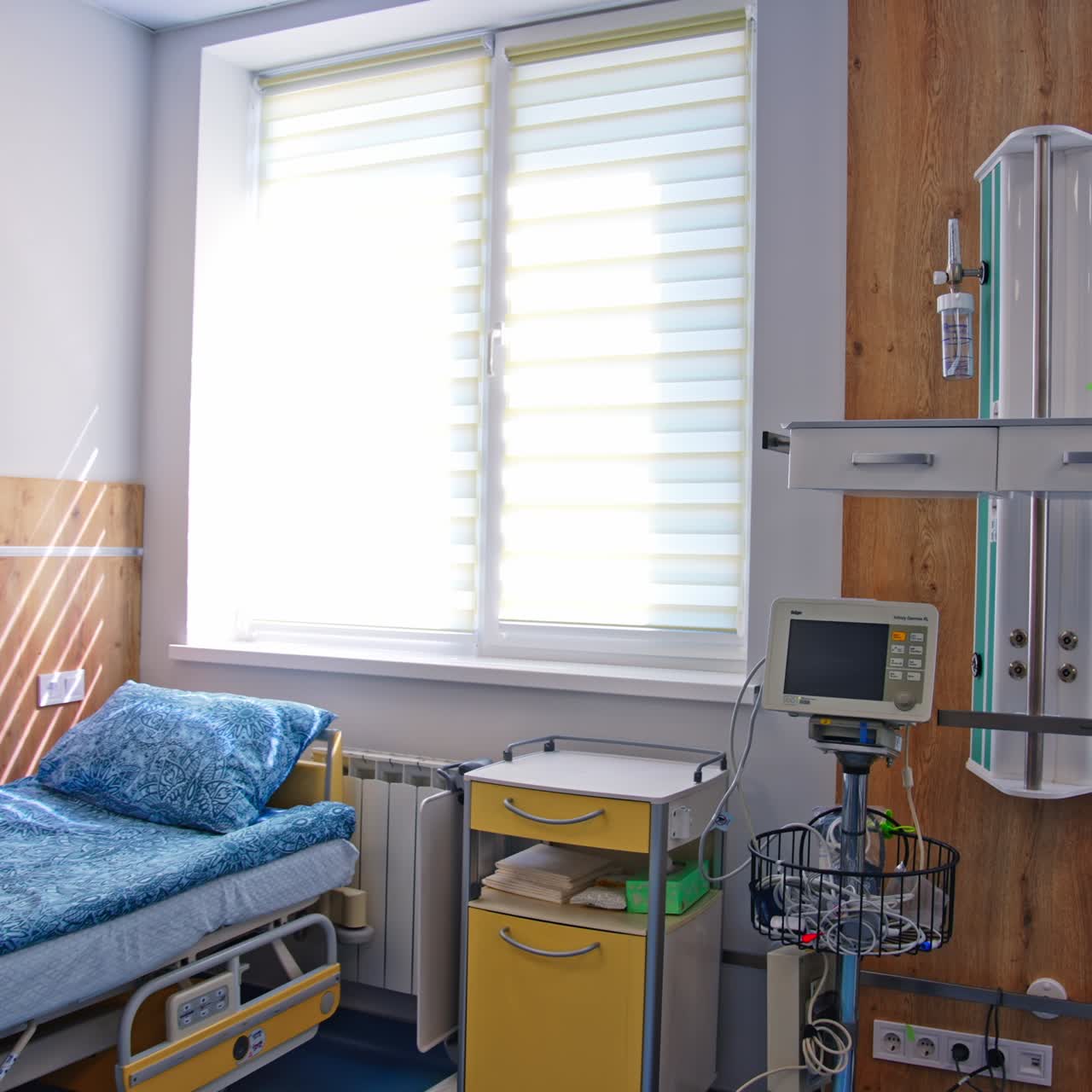 Light spacious modern room for patients after resuscitation ward. Hospital room with two beds on wheels and other equipment