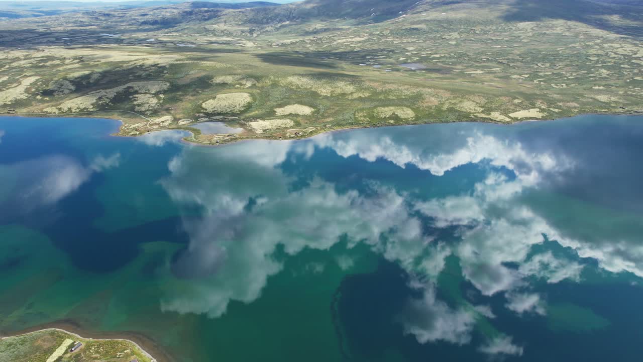 Slow rotating aerial view of Orkelsjoen showing calm turquoise water with vivid sky reflections in pristine landscape