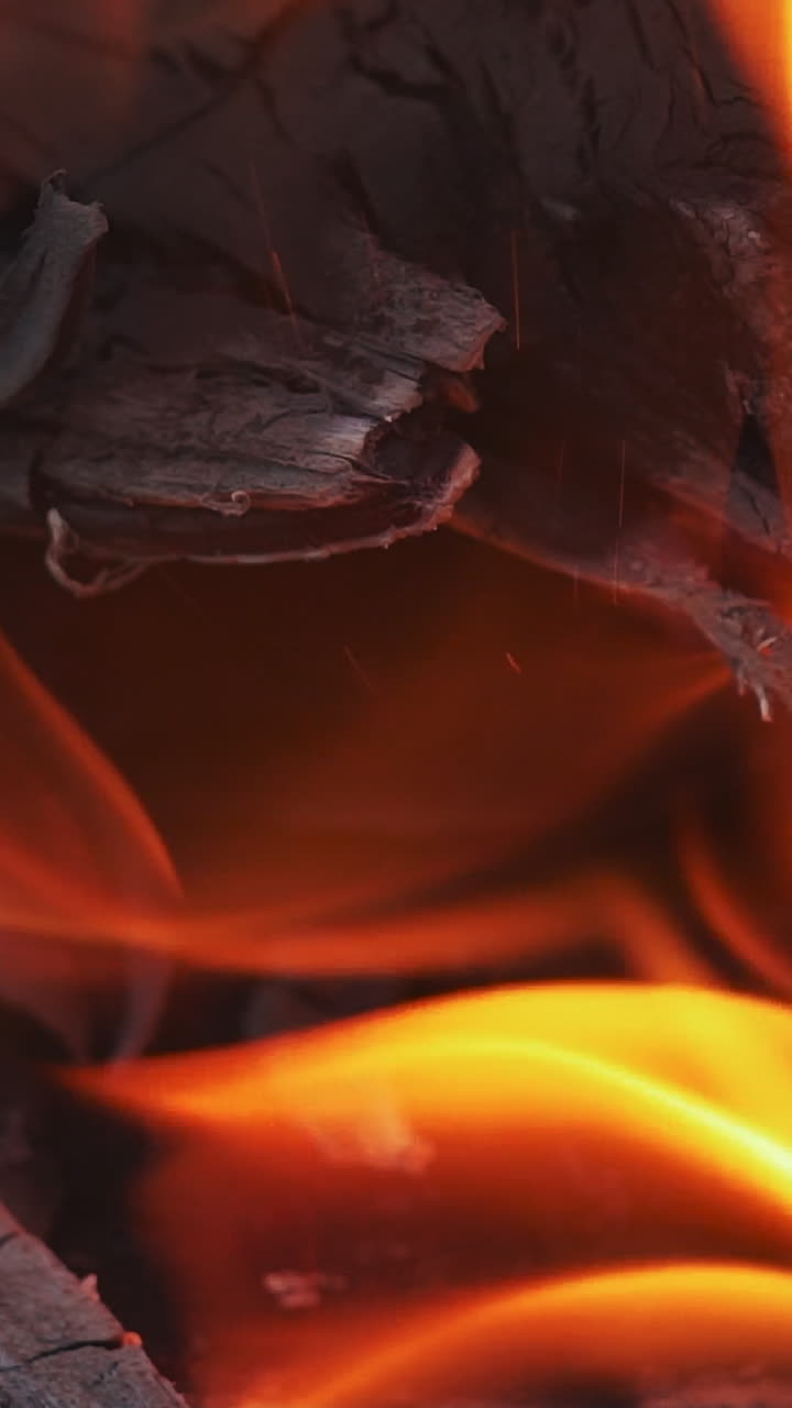 Fire flame concept. Real flame fire burning wood to ash. Vertical video
