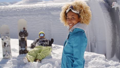cute skier in front of friend in snow