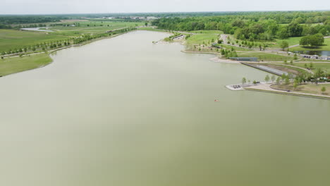 Shelby-farms-park-with-a-lake,-greenery,-and-visitors-enjoying-the-outdoors,-bright-day,-aerial-view