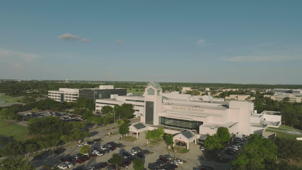 A half orbit aerial 4K drone view of Memorial Hermann Hospital Southeast at late evening in Houston, Texas.