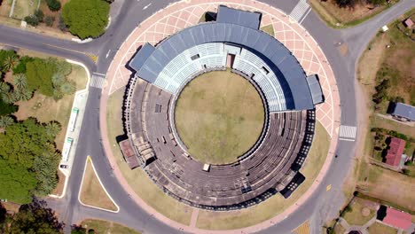 Top-view-rotating-aerial-view-of-the-circle-design-of-the-Real-de-San-Carlos-bullring,-sunny-day,-Colonia-del-Sacramento,-Uruguay