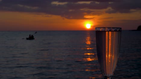 a cocktail at sunset with a kayak in the ocean