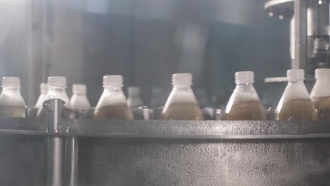 conveyor belt with bottles for juice or water at a modern beverage plant. modern production of sweet soda water