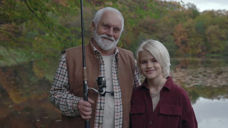 grandfather and grandson fishing together in autumn