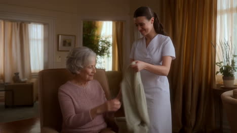 caregiver assists an elderly woman at home