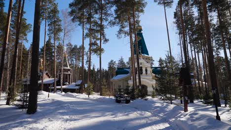 snowy orthodox church in a forest