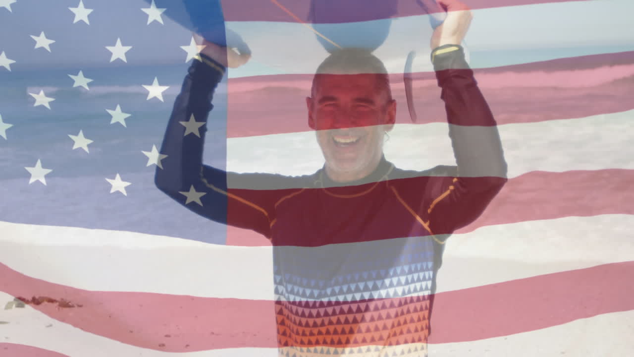 Animation of american flag waving over senior man carrying surfboard on head on beach