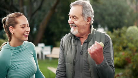senior man exercising with young woman outdoors
