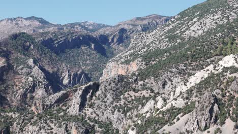 exposed white grey rocks dotted with low shrubs in taurus mountains turkey